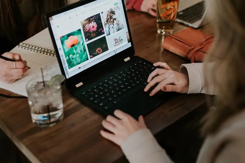 Hands on a laptop with a design portfolio
