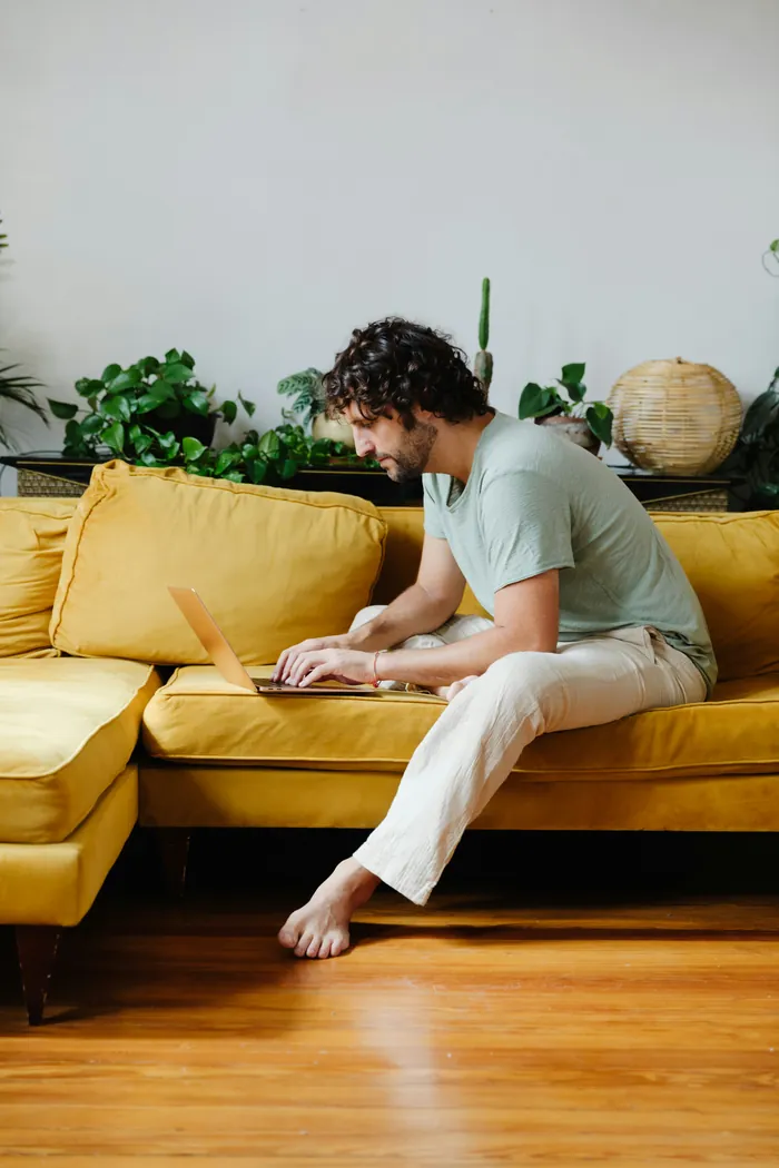 Learner working from a yellow sofa