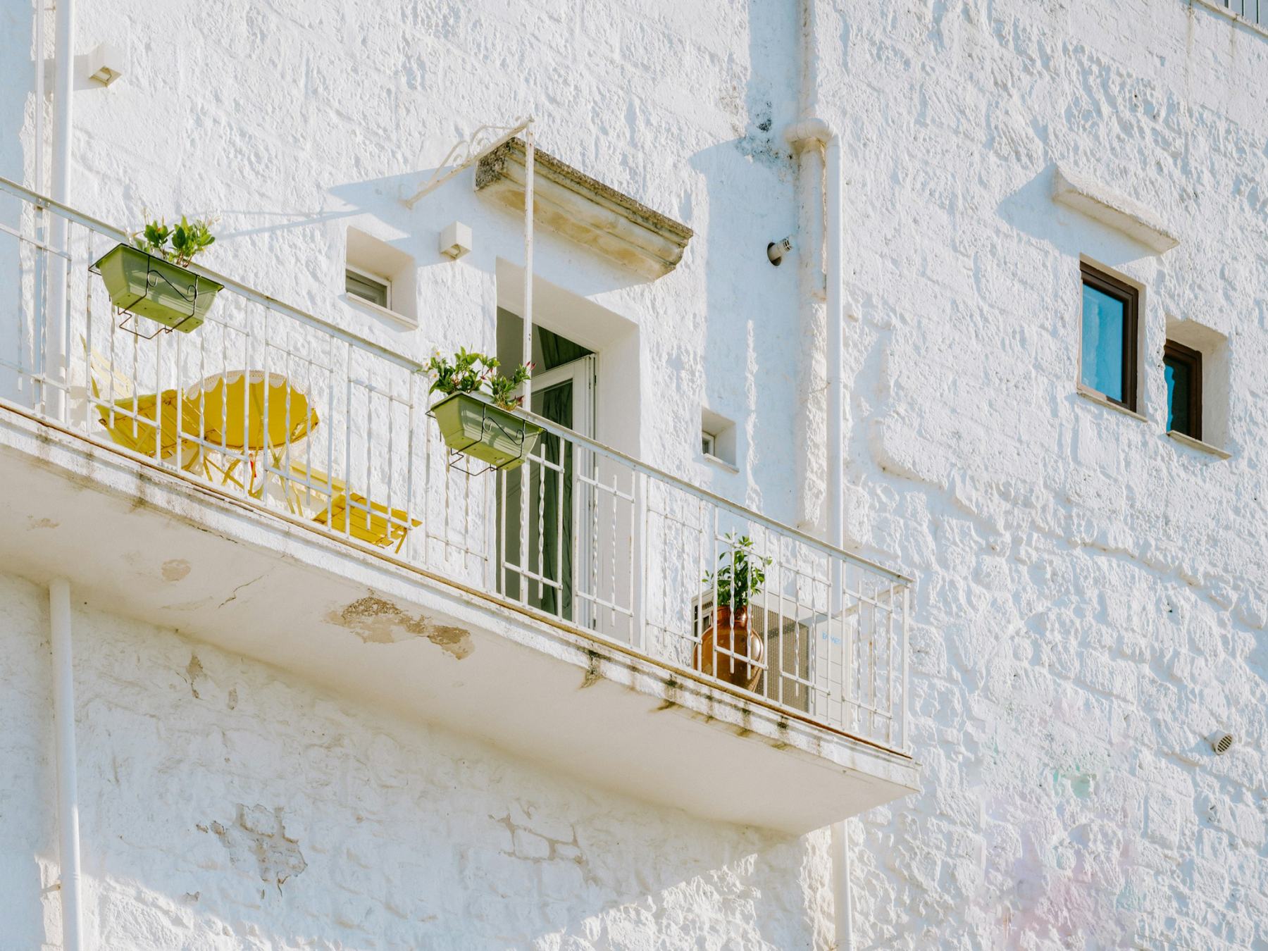 Lime-washed wall with a small balcony