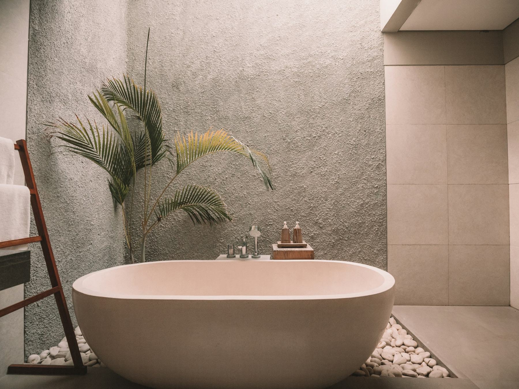 Stone bathtub in a bathroom with lime plaster walls